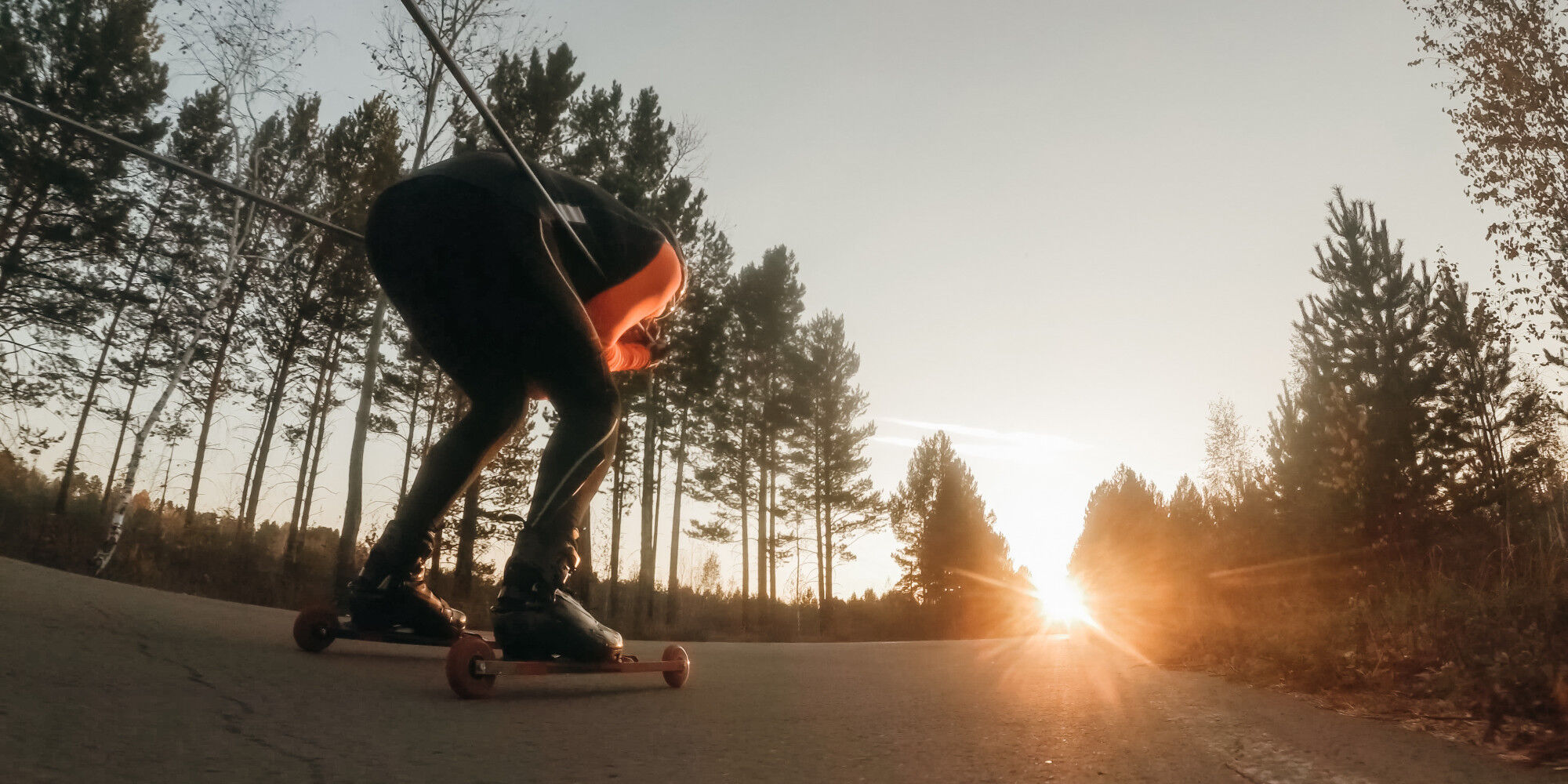 monsieur tout schuss sur des skis roues avec le soleil couchant
				        