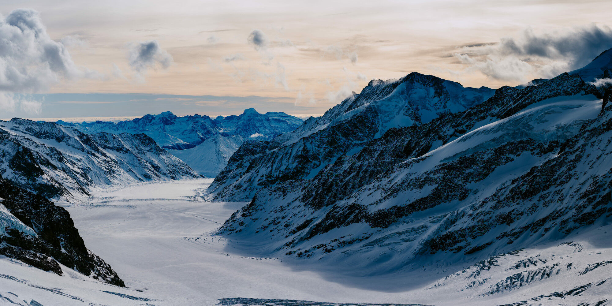 photo of the snow-covered mountain and small clouds
				        
