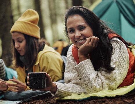 femmes dans des sacs de couchage qui font du camping
					        