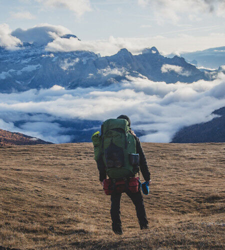 Woman carrying a hiking rucksack
		                        