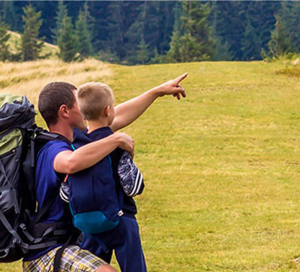 dad and child in the great outdoors
					                    