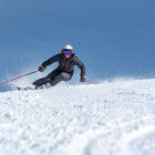 skier hurtling down the snowy slopes
			                