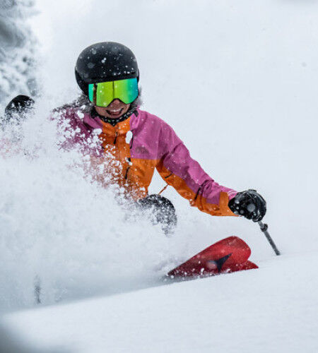 skier in the snow with Atomic skis
		                        
